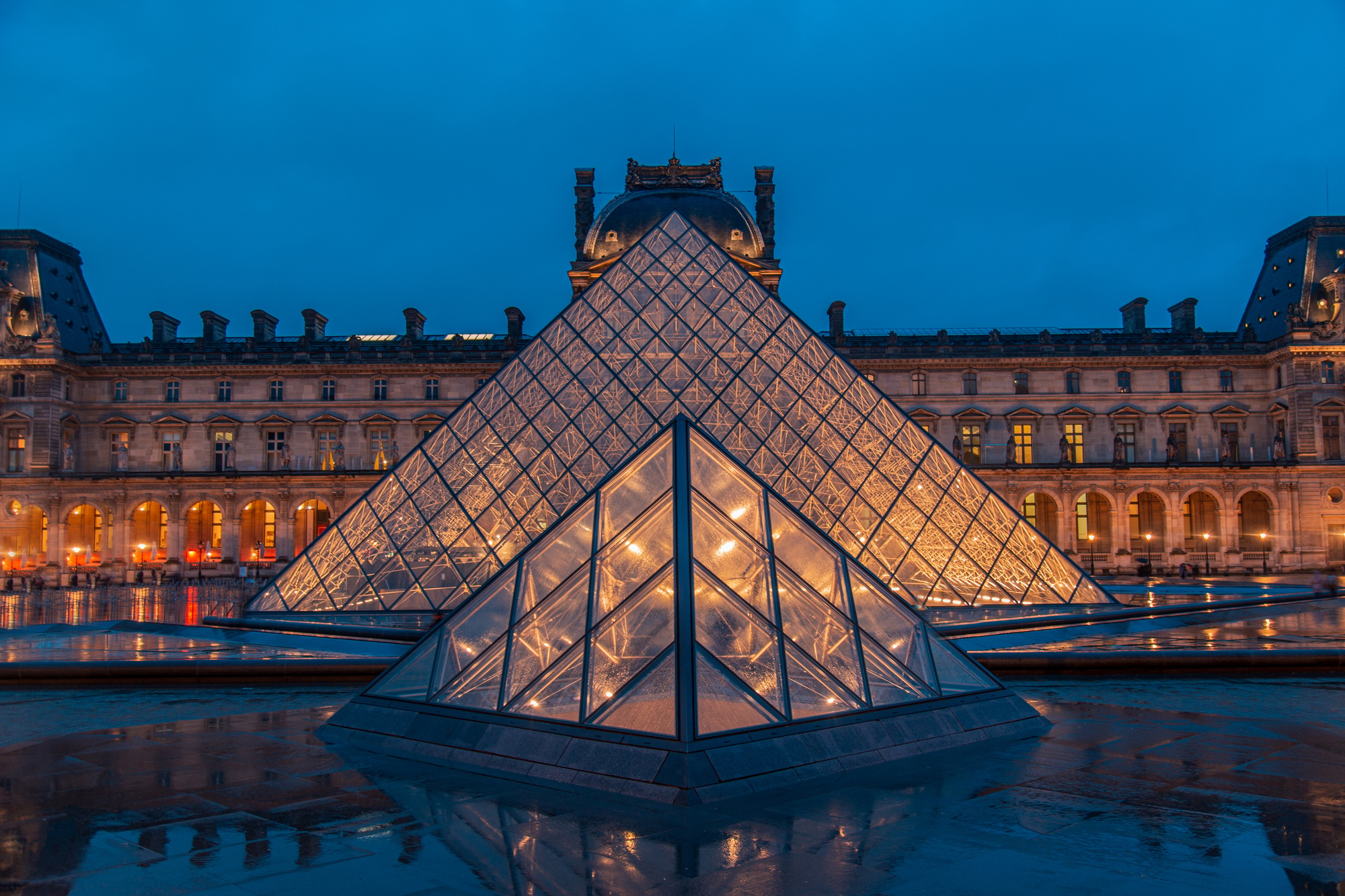 Amazing view from a Louvre Pyramid from a dark and moody day with rainy weather | SUPERPOBYT European