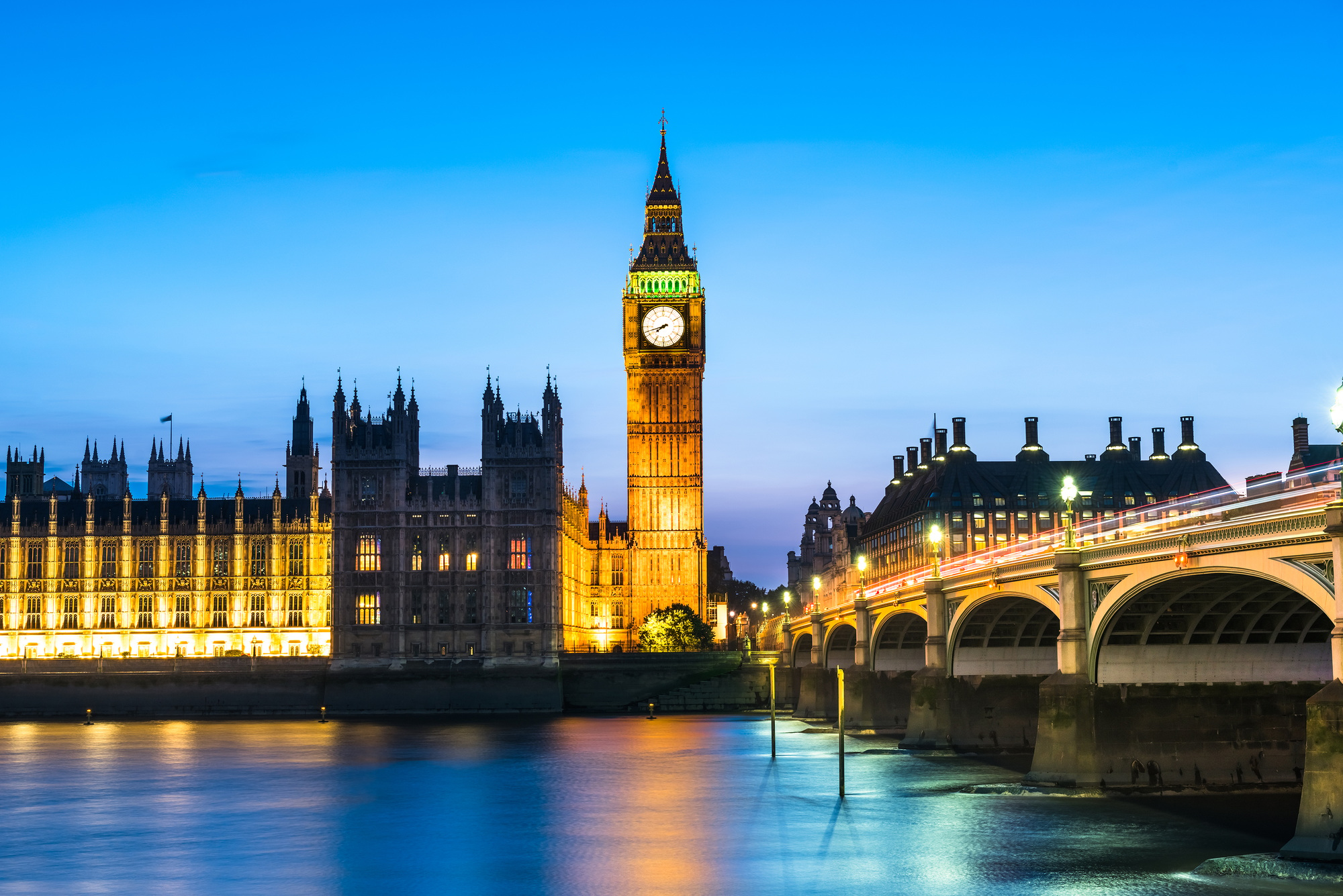 Westminster abbey and big ben in the London skyline at night, London, UK